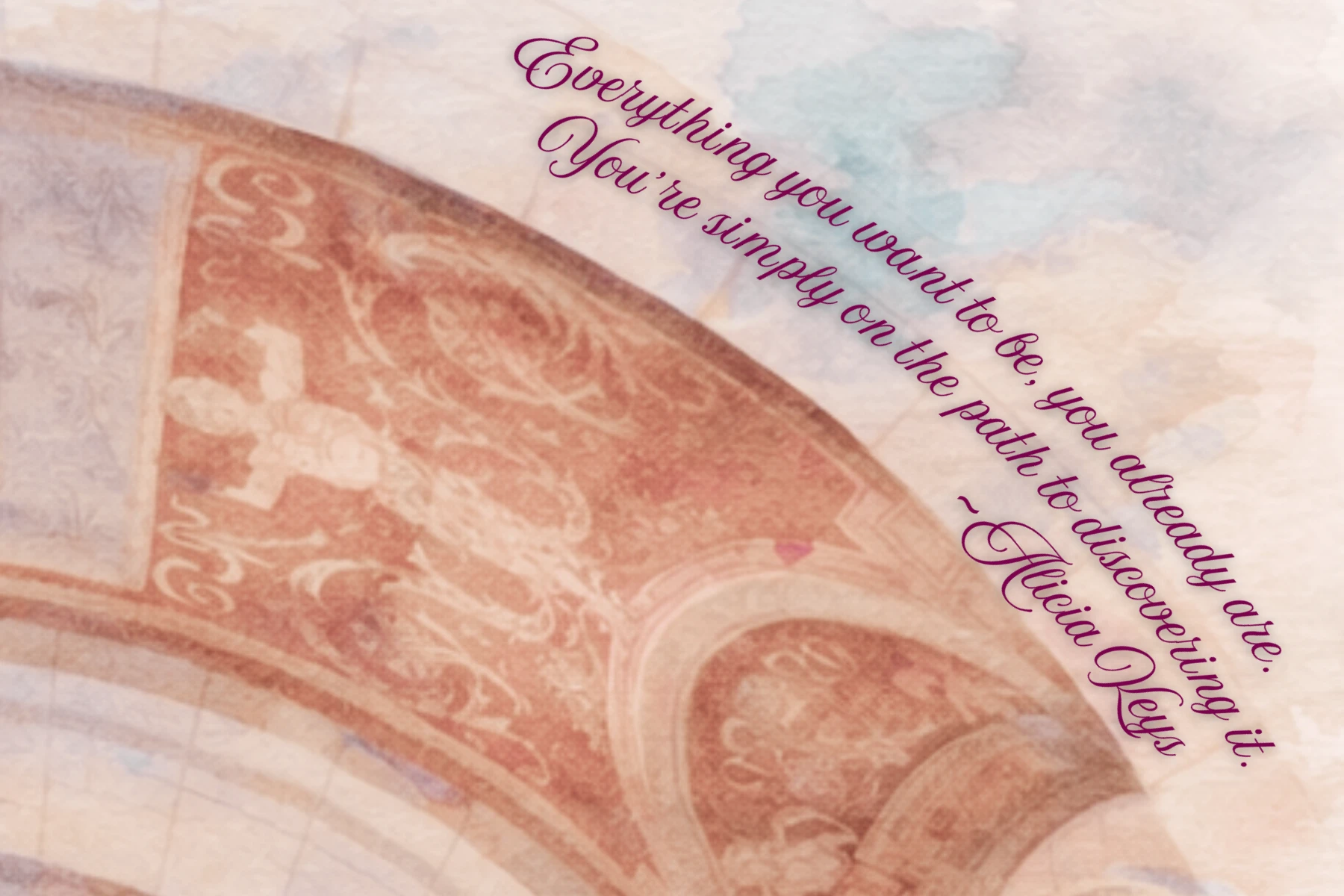 The front of a postcard: a soft, painterly view of a carved archway, with a quote from Alicia Keys in plum script across the sky.