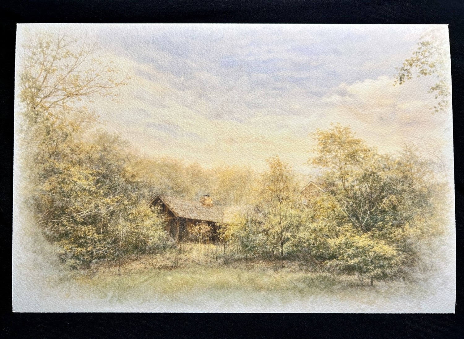 A gicl&eacute;e print of a house half hidden among trees, its roof rising through the branches in soft golden light, printed on textured 100&percnt; cotton fiber paper.