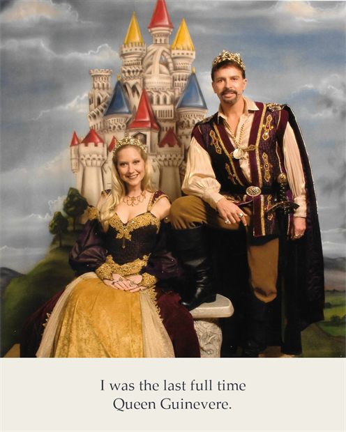 Susannah in a gold and ivory gown beside a king in a red cloak, a castle behind them.